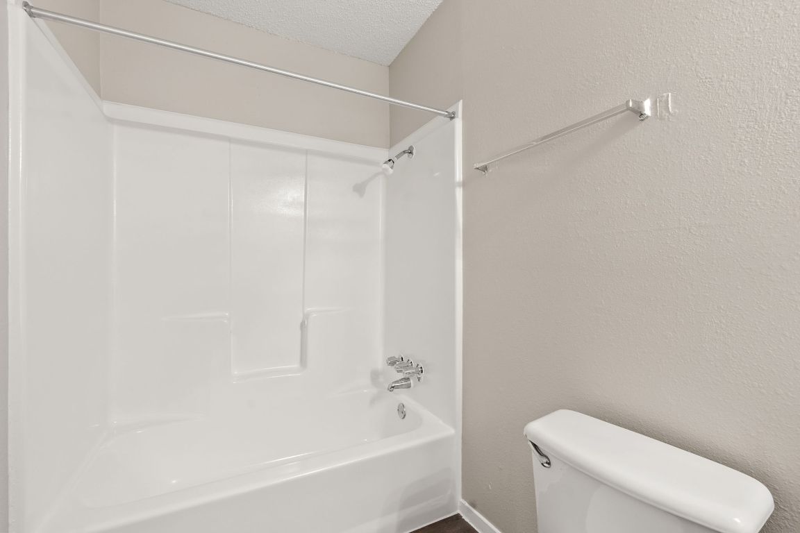 2001 South Interstate 35 Frontage Road, Unit 101 Austin, TX 78741 - Photo 12 of 24 a bathroom with a bathtub and a toilet