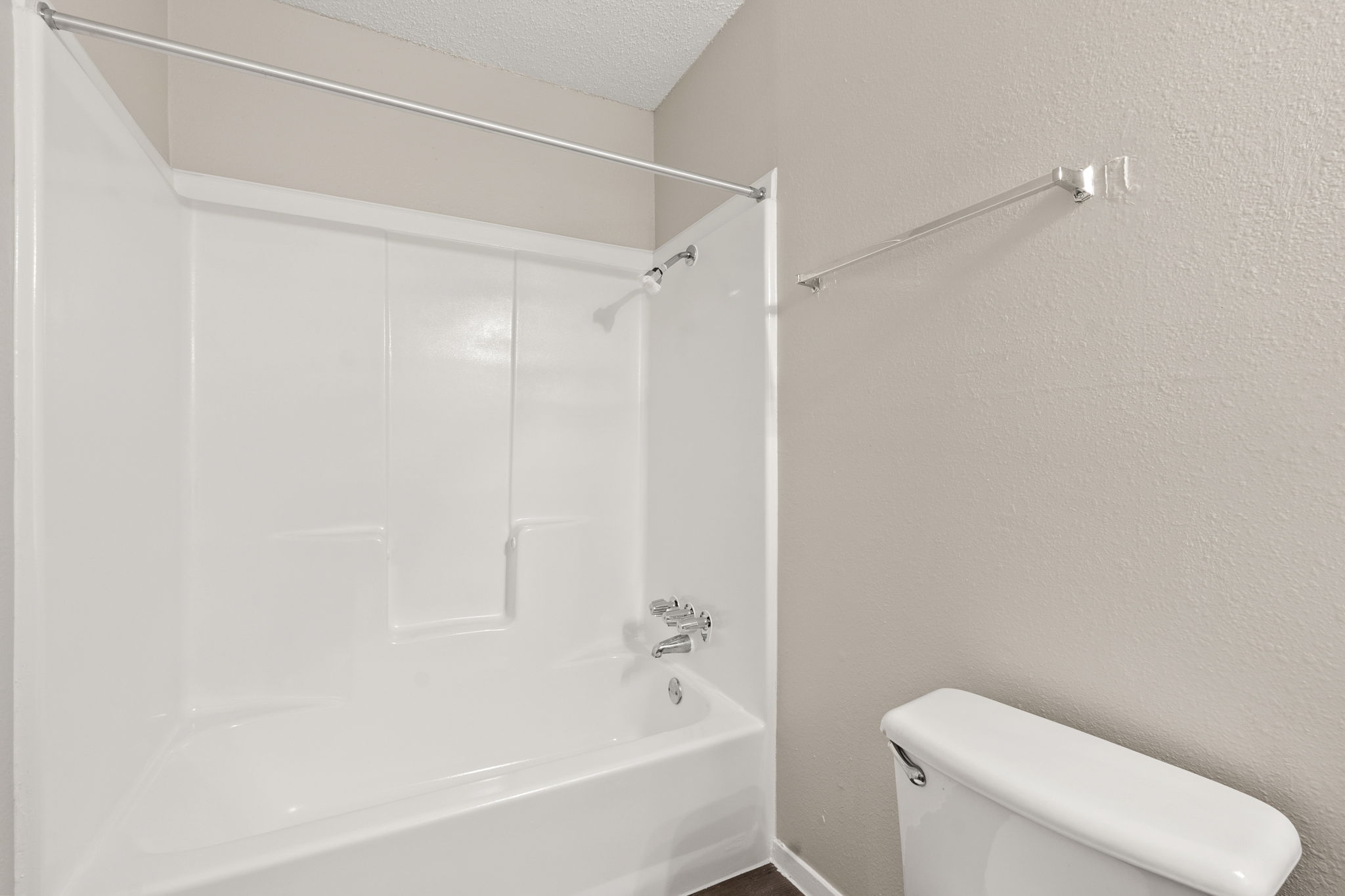 2001 South Interstate 35 Frontage Road, Unit 229 Austin, TX 78741 - Photo 12 of 24 Full bathroom with a textured wall, washtub / shower combination, and a textured ceiling