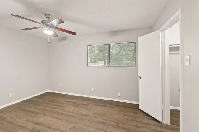a view of empty room with wooden floor