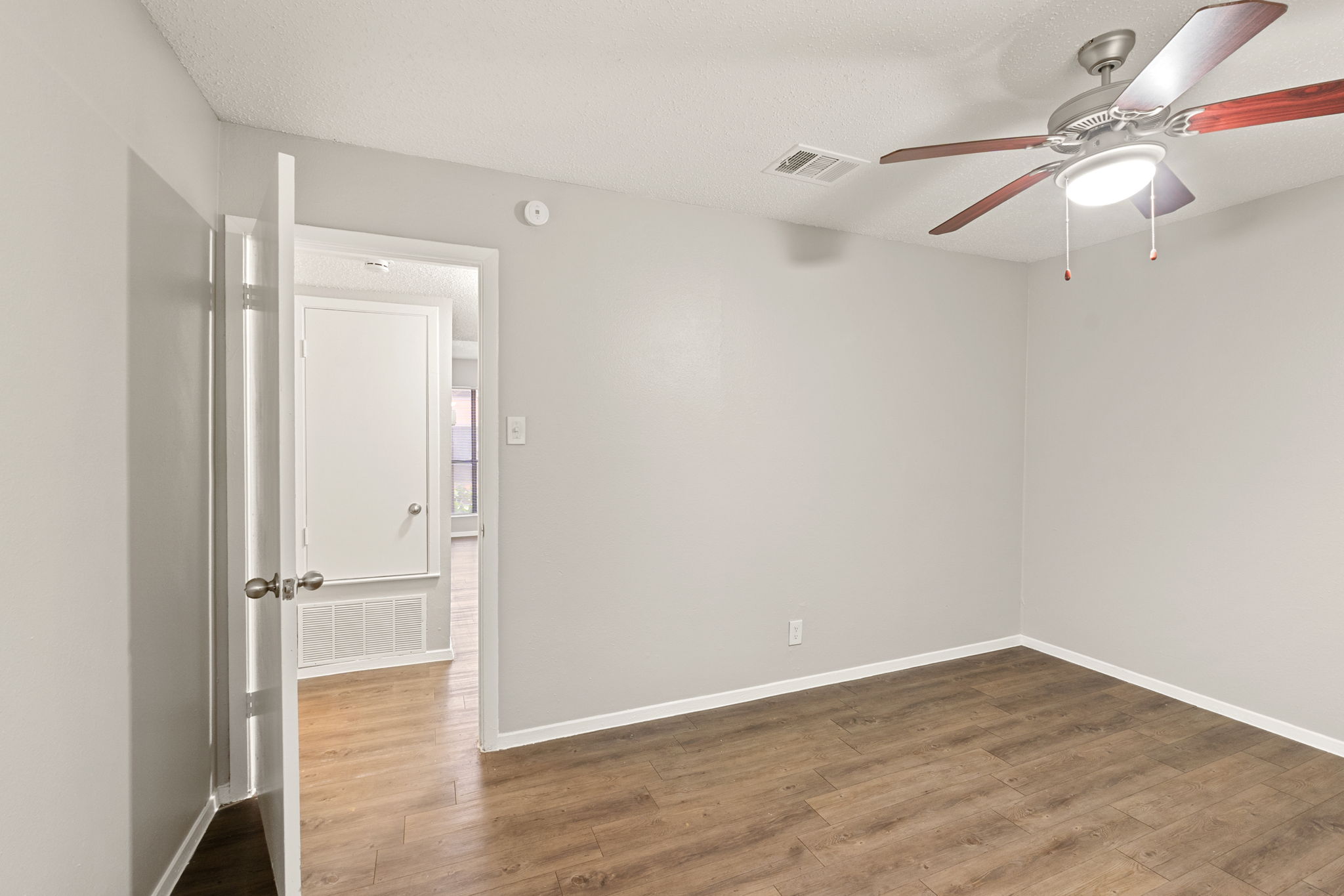 2001 South Interstate 35 Frontage Road, Unit 229 Austin, TX 78741 - Photo 15 of 24 Spare room featuring dark wood-style floors and a ceiling fan