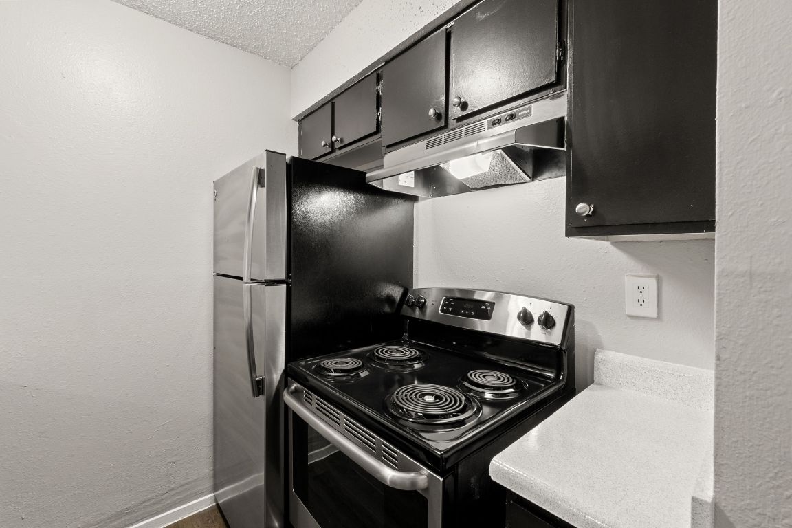 2001 South Interstate 35 Frontage Road, Unit 101 Austin, TX 78741 - Photo 2 of 24 a kitchen with a stove and a refrigerator
