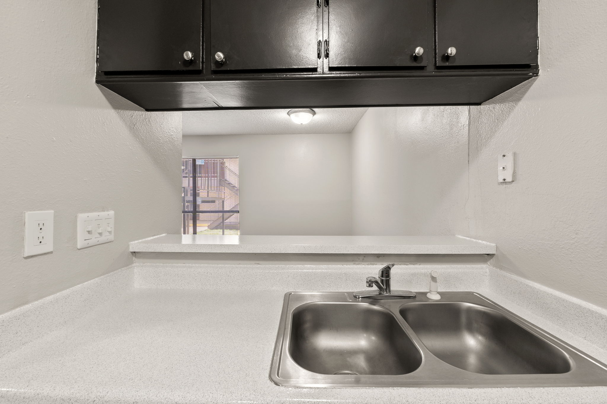 2001 South Interstate 35 Frontage Road, Unit 229 Austin, TX 78741 - Photo 6 of 24 Kitchen view of a textured wall and light countertops