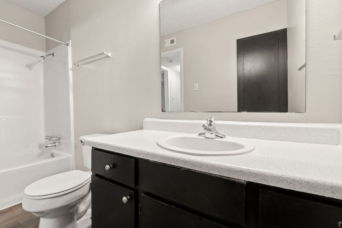 2001 South Interstate 35 Frontage Road, Unit 101 Austin, TX 78741 - Photo 10 of 24 a bathroom with a sink a toilet a shower and a mirror
