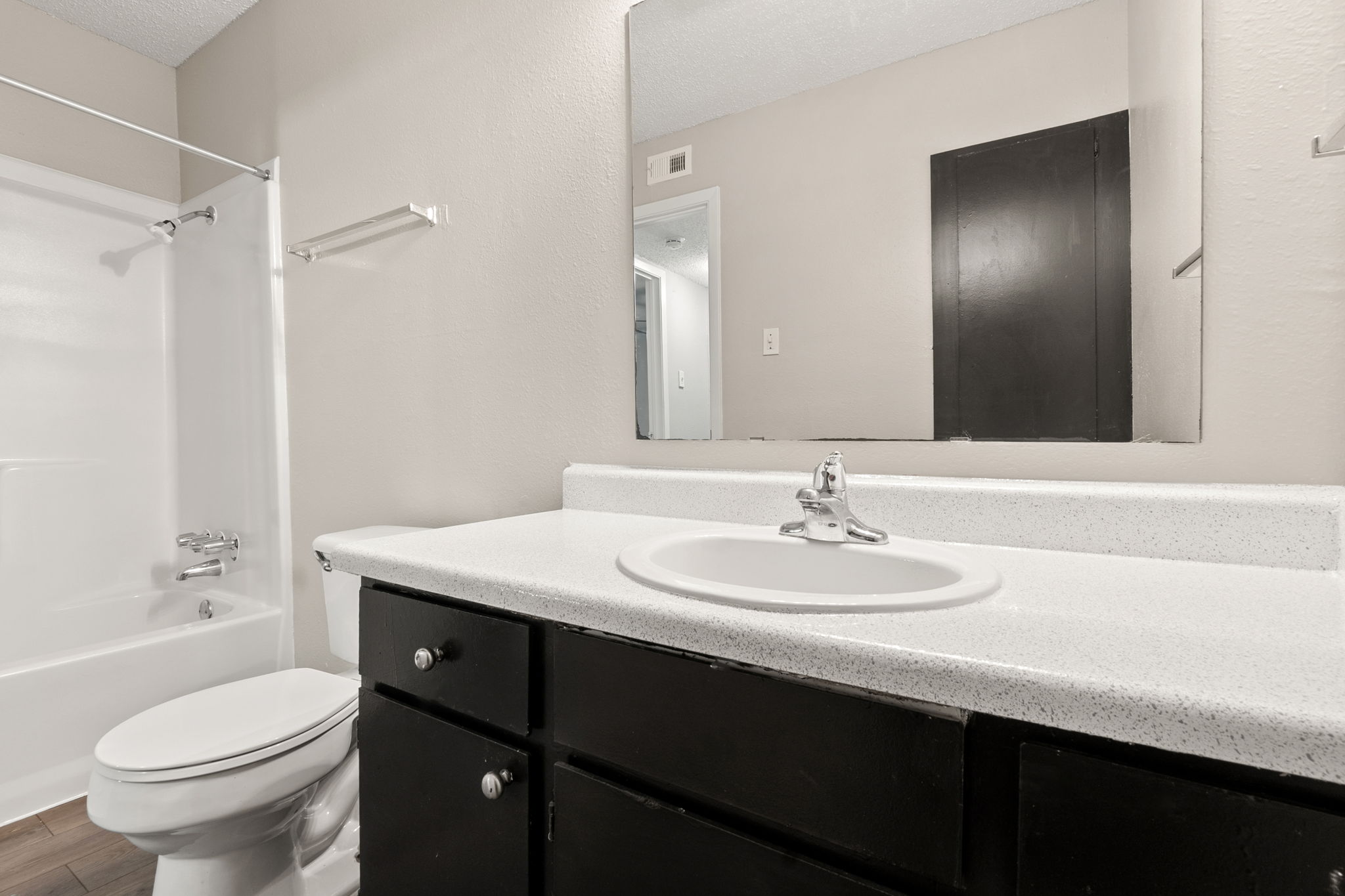 2001 South Interstate 35 Frontage Road, Unit 229 Austin, TX 78741 - Photo 10 of 24 Full bathroom featuring bathtub / shower combination, vanity, wood finished floors, and a textured ceiling