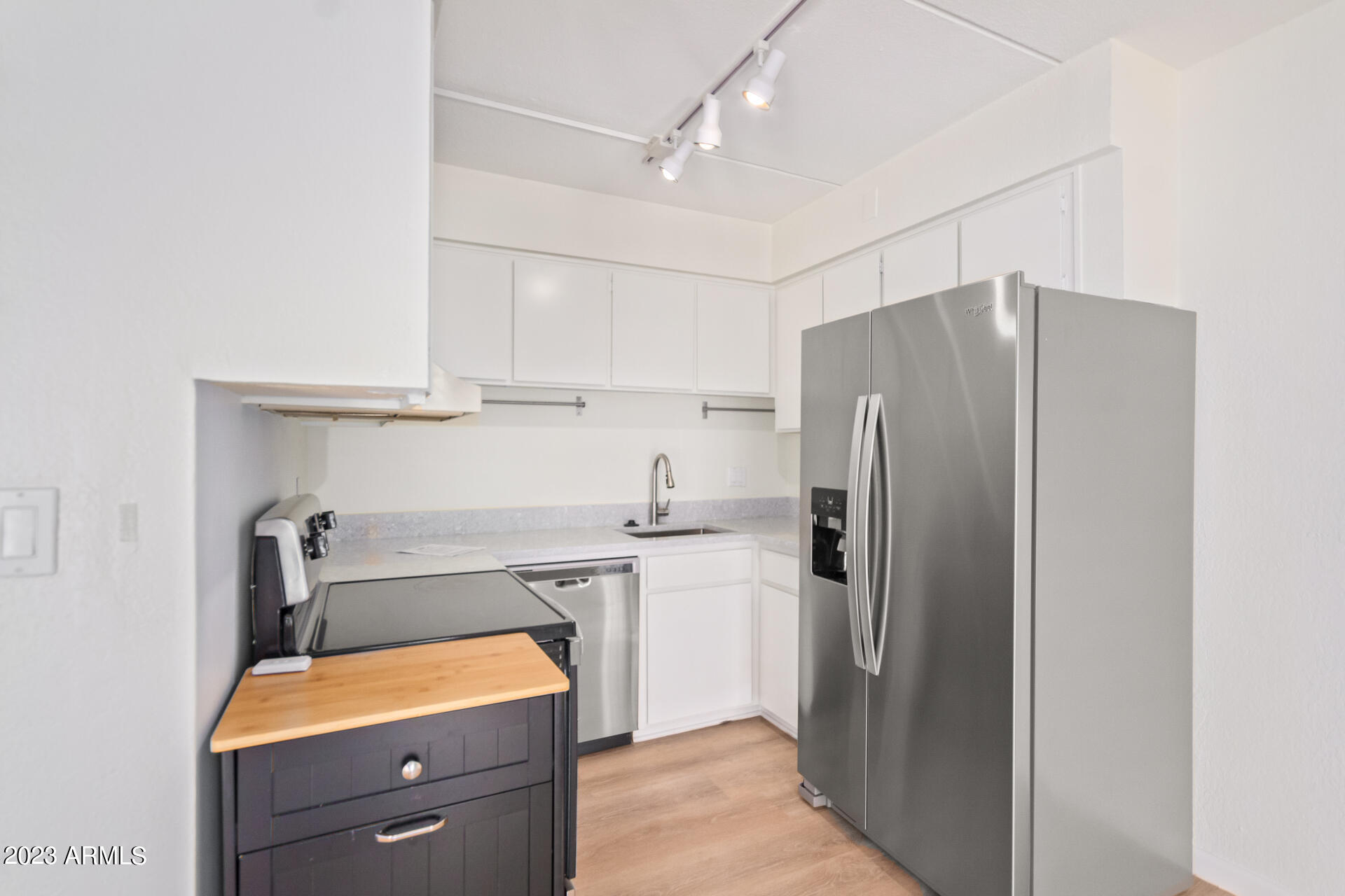 1024 East Osborn Road, Unit B Phoenix, AZ 85014 - Photo 10 of 21 a kitchen with stainless steel appliances a refrigerator and a sink