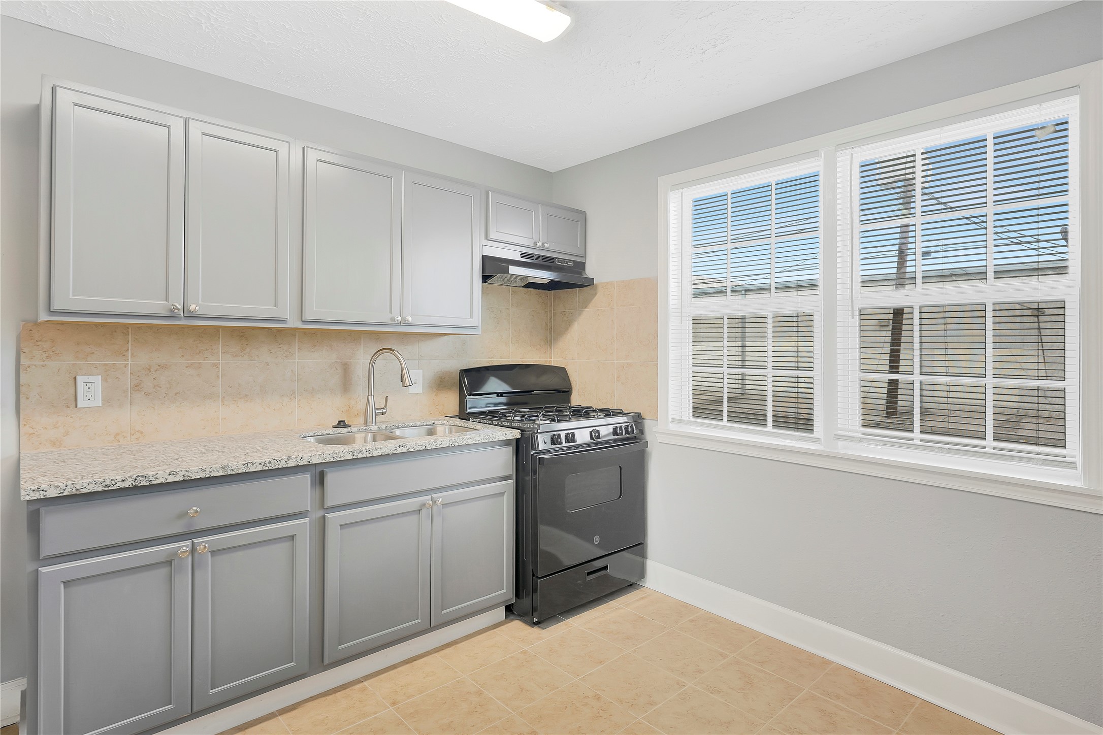 2311 North Louis Street Victoria, TX 77901 - Photo 4 of 18 a kitchen with a sink cabinets and window