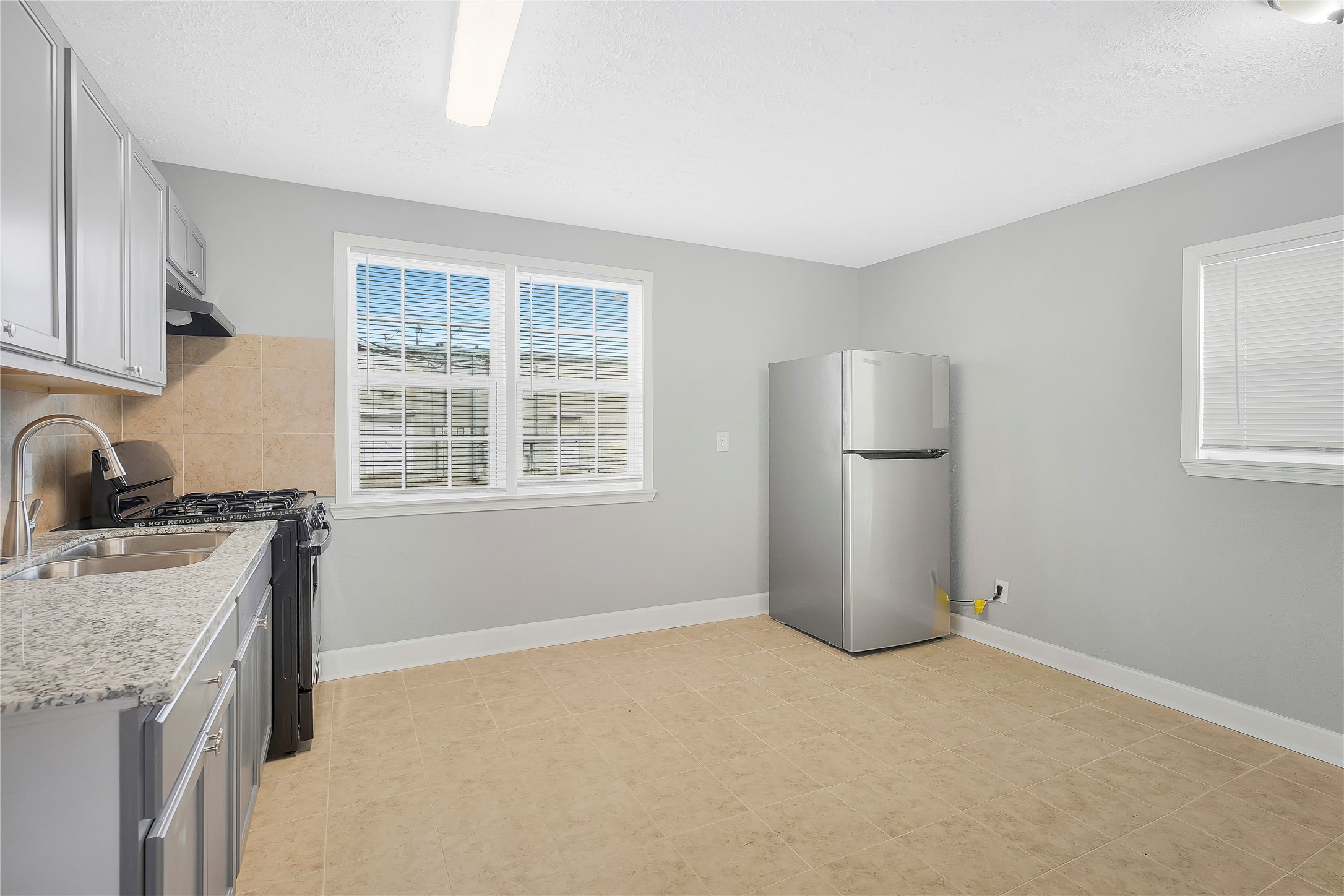 2311 North Louis Street Victoria, TX 77901 - Photo 5 of 18 a view of a kitchen with a sink dishwasher and a refrigerator