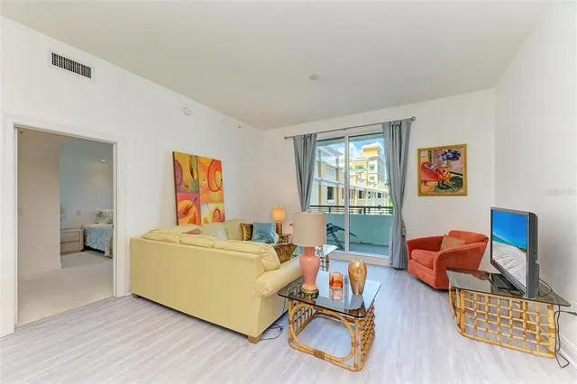 a large white kitchen with a sink and dishwasher a stove top oven with wooden floor