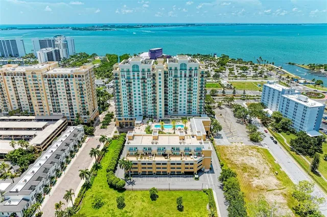 an aerial view of a house with a yard and lake view