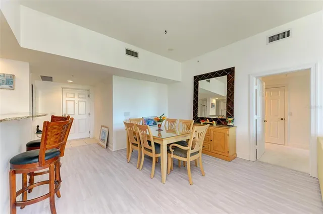 a bedroom with a bed and a flat tv screen on dresser