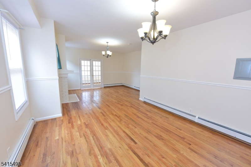 117 Scheerer Avenue Newark, NJ 07112 - Photo 17 of 19 wooden floor in an empty room with a window