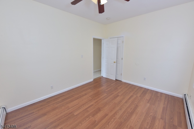 117 Scheerer Avenue Newark, NJ 07112 - Photo 8 of 19 a view of an empty room with wooden floor