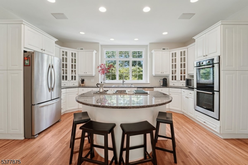 14 Broadway Road Warren, NJ 07059 - Photo 17 of 45 a kitchen with stainless steel appliances a dining table chairs refrigerator and stove