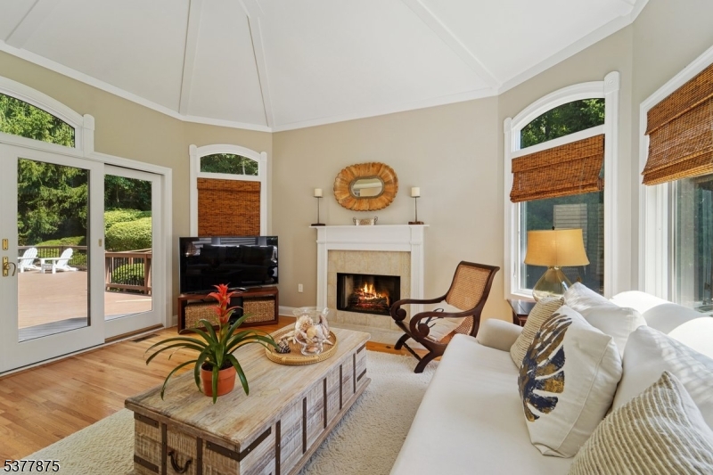 14 Broadway Road Warren, NJ 07059 - Photo 20 of 45 a living room with furniture a fireplace and floor to ceiling windows