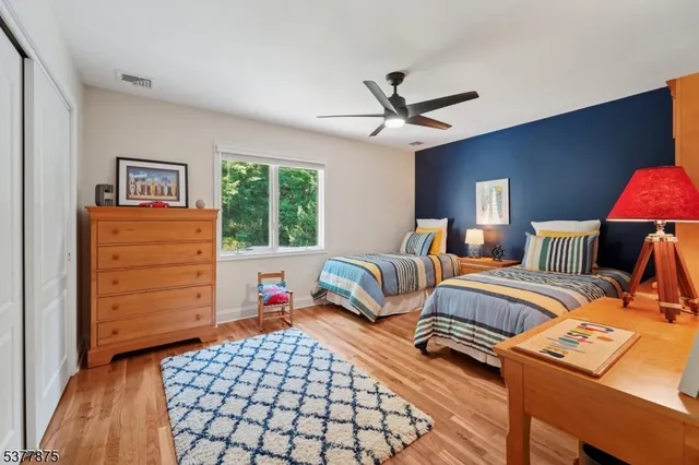 a bedroom with a bed dresser and a window