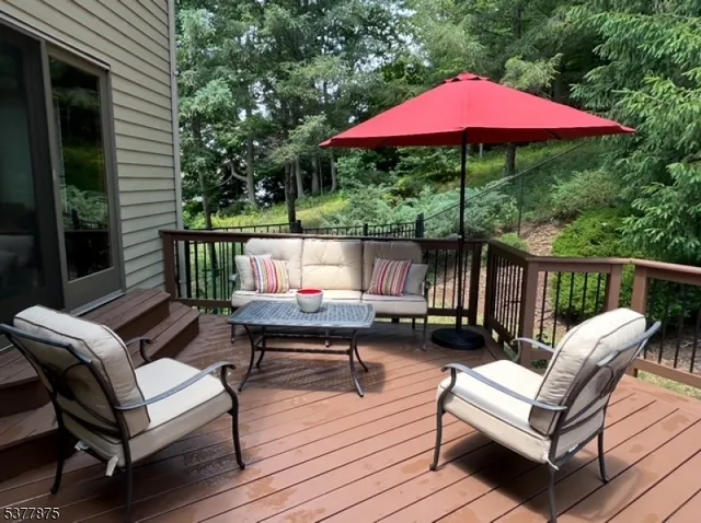 a view of a deck with furniture and a backyard