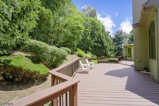 a balcony with wooden floor and outdoor seating