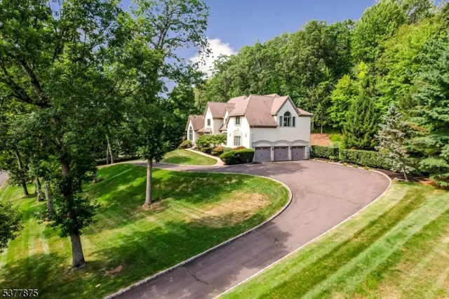 a aerial view of a house with swimming pool and a yard