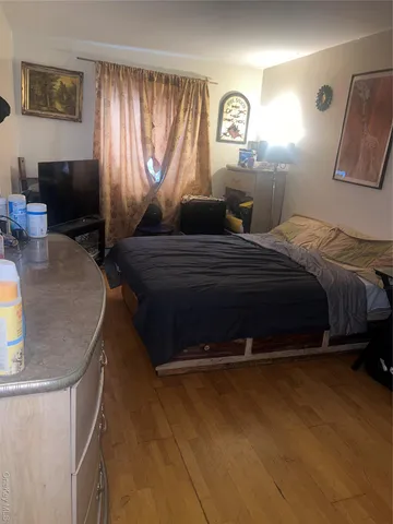 a bedroom with a bed and window