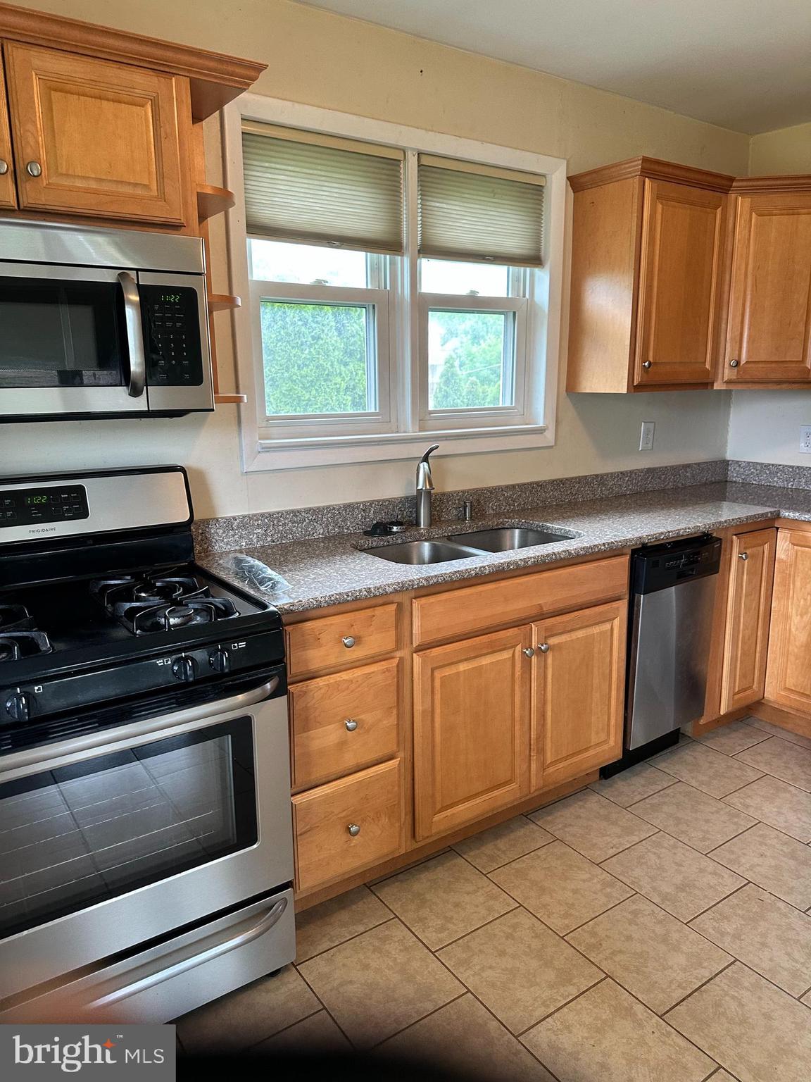 102 Myrtle Avenue Reading, PA 19606 - Photo 4 of 11 a kitchen with granite countertop stainless steel appliances a stove sink and microwave