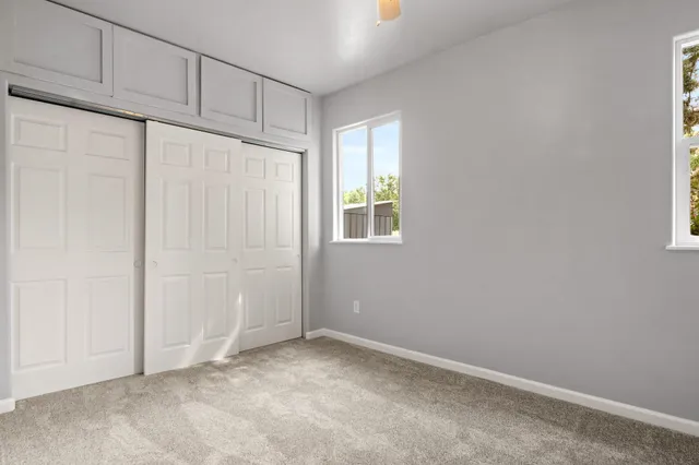 a view of a big room with closet and windows