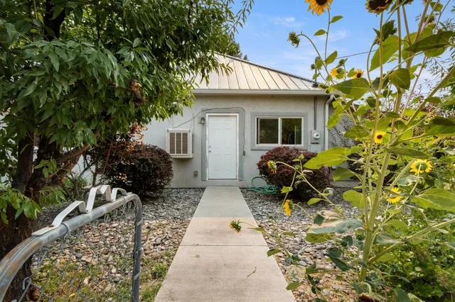 a front view of a house with garden