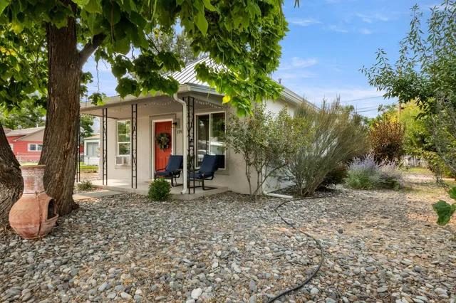 a front view of a house with a garden