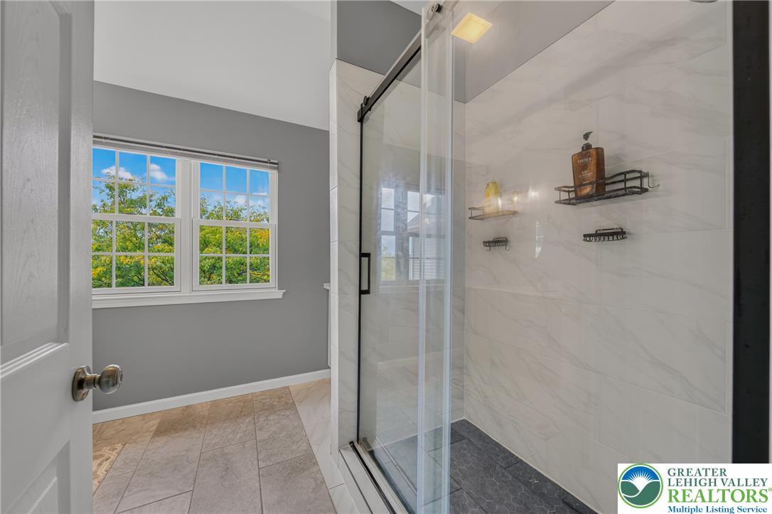4236 Creek Road Allentown, PA 18104 - Photo 23 of 47 Natural light pours through multipane windows onto a tile floor and walk-in shower.