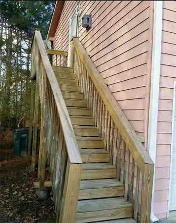 a view of a kitchen with stainless steel appliances granite countertop a sink a stove and refrigerator