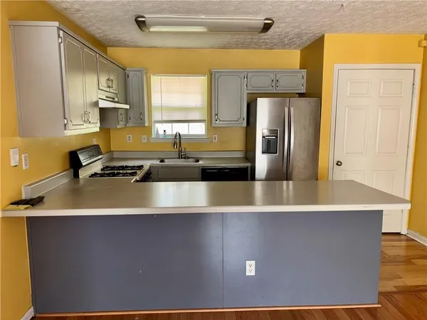 a kitchen with a refrigerator and a sink
