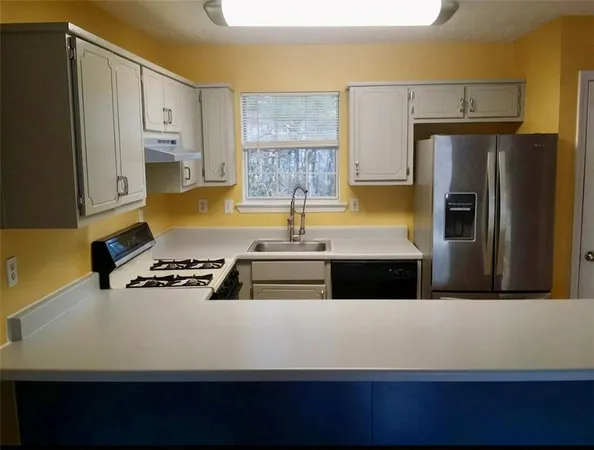a view of a kitchen with a sink and wooden floor