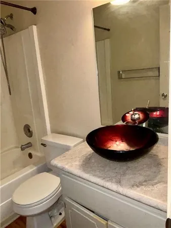 a view of empty room with wooden floor and fireplace