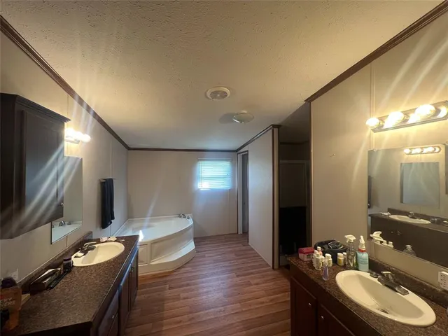 a bathroom with a sink double vanity granite and a mirror