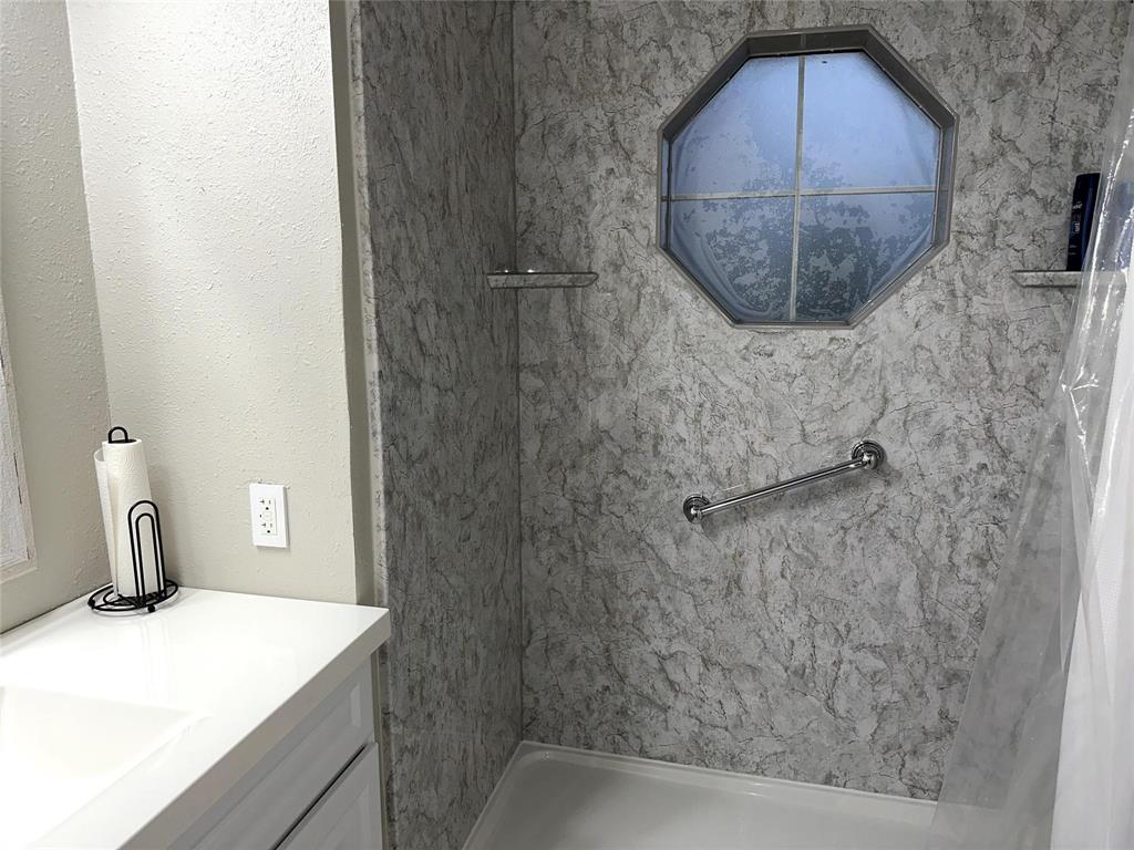 520 Red River Road Belton, TX 76513 - Photo 17 of 36 Bathroom featuring vanity and a marble finish shower