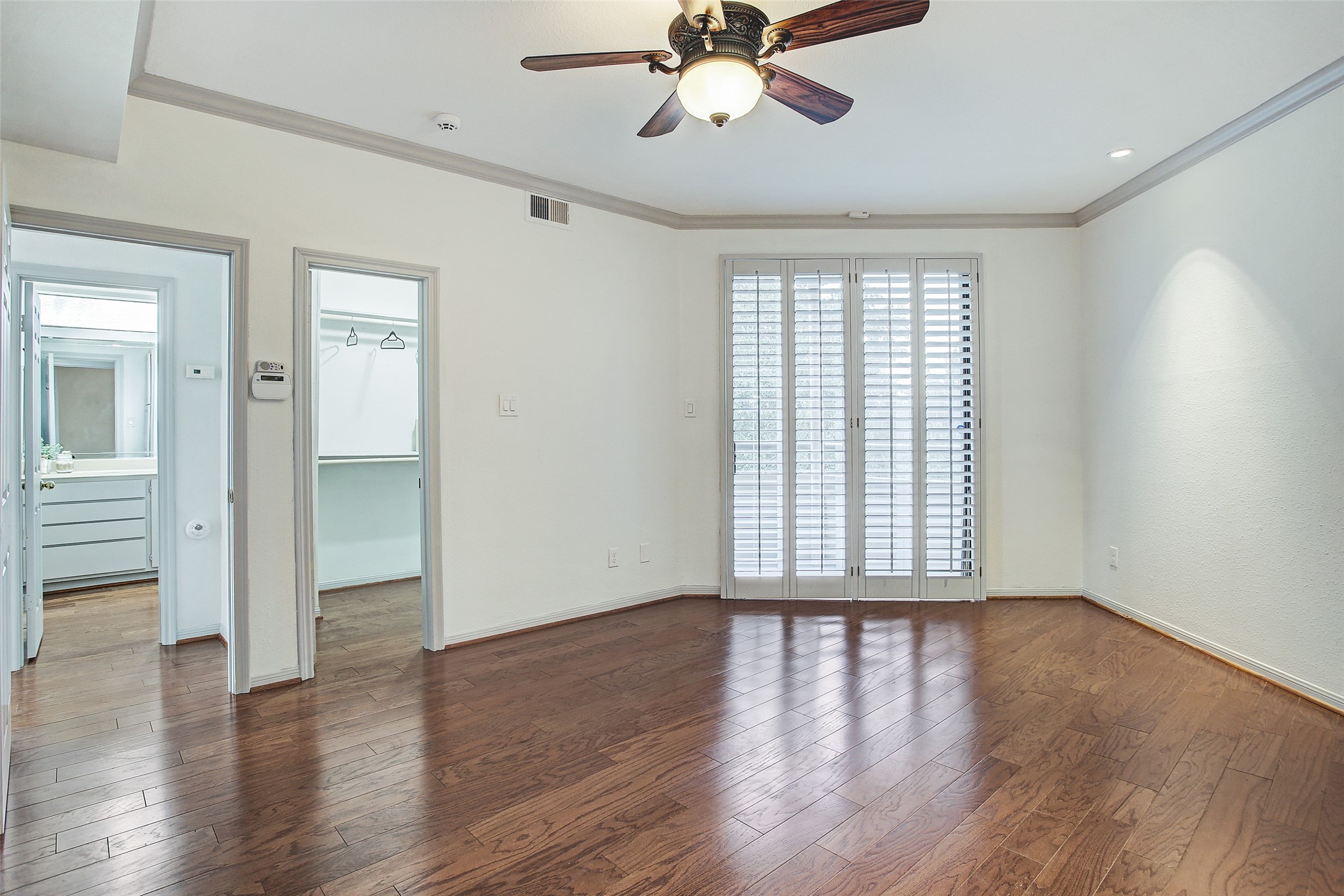 5220 Weslayan Street, Unit 310 Houston, TX 77005 - Photo 12 of 18 a view of an empty room with wooden floor and a window