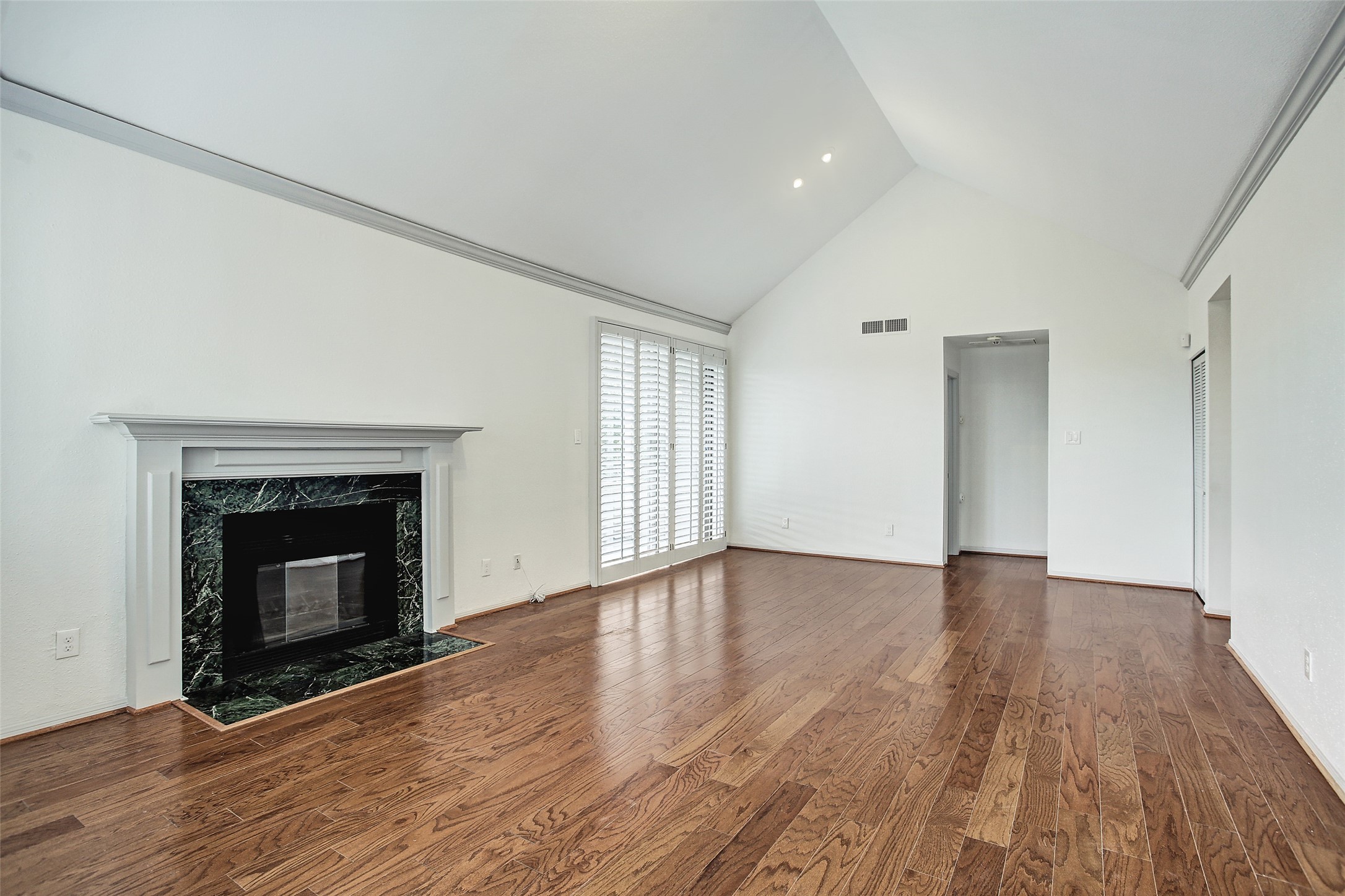 5220 Weslayan Street, Unit 310 Houston, TX 77005 - Photo 2 of 18 a view of an empty room with wooden floor and a fireplace