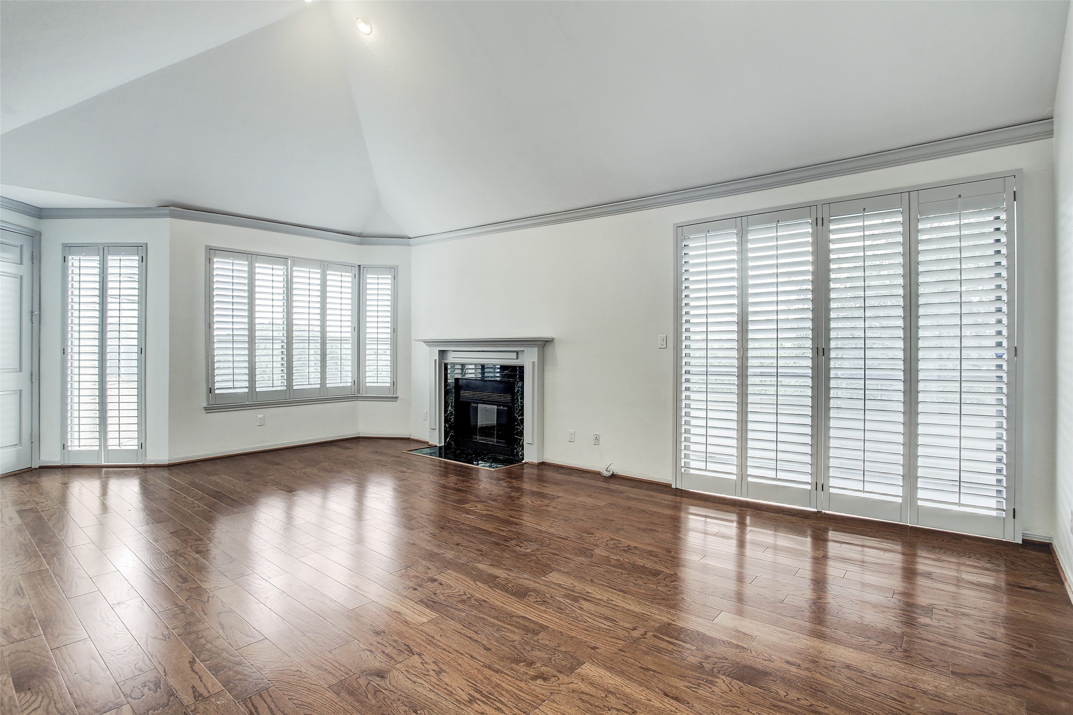 5220 Weslayan Street, Unit 310 Houston, TX 77005 - Photo 4 of 18 an empty room with wooden floor and windows