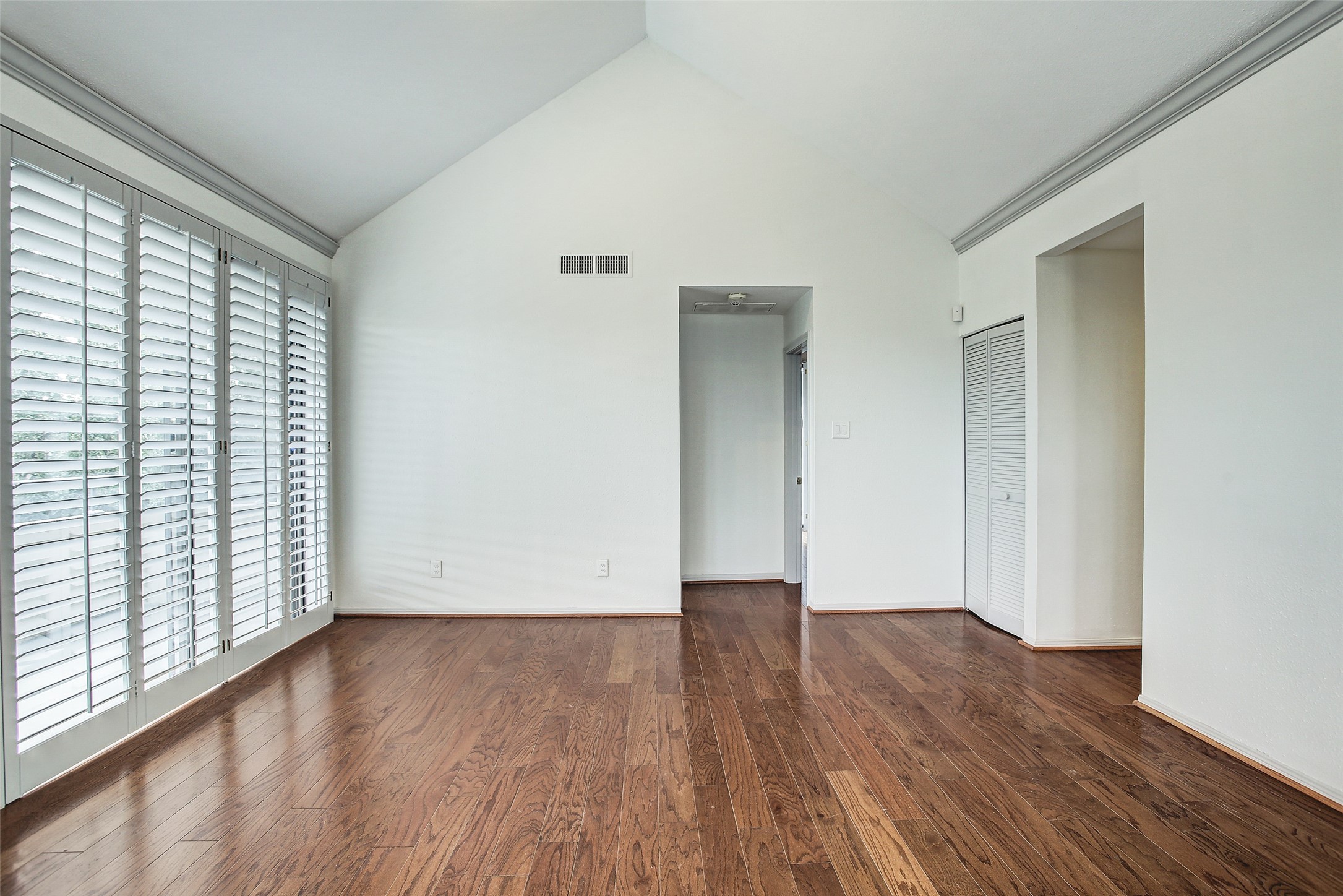 5220 Weslayan Street, Unit 310 Houston, TX 77005 - Photo 5 of 18 a view of an empty room with wooden floor and a window