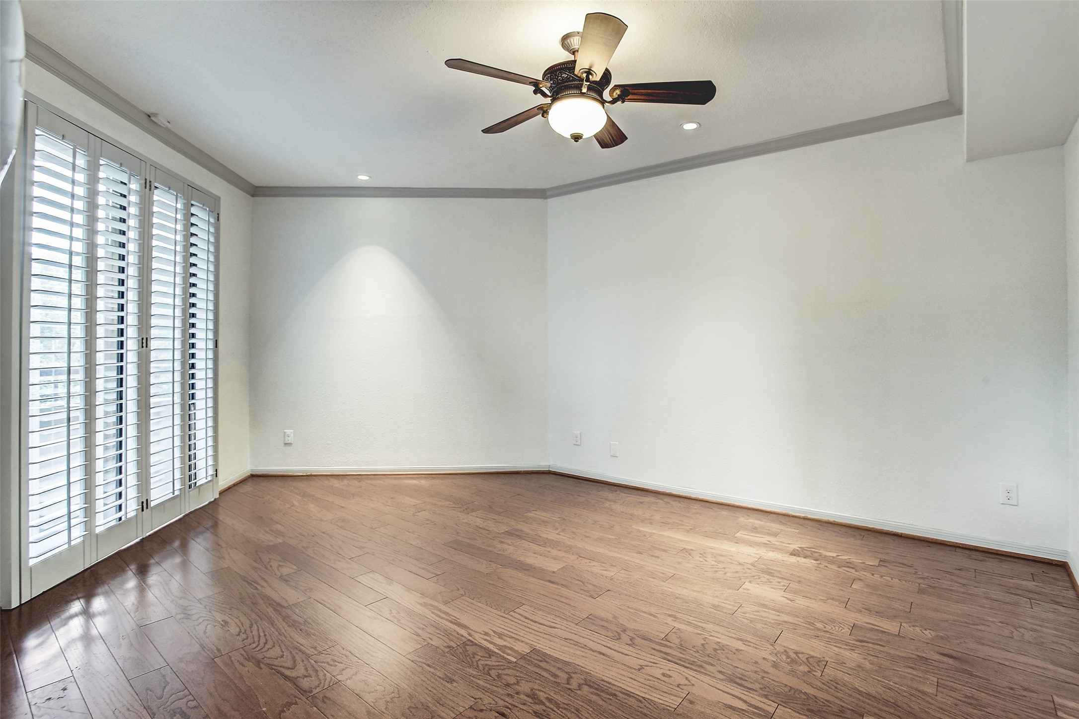 5220 Weslayan Street, Unit 310 Houston, TX 77005 - Photo 10 of 18 wooden floor in an empty room with a window