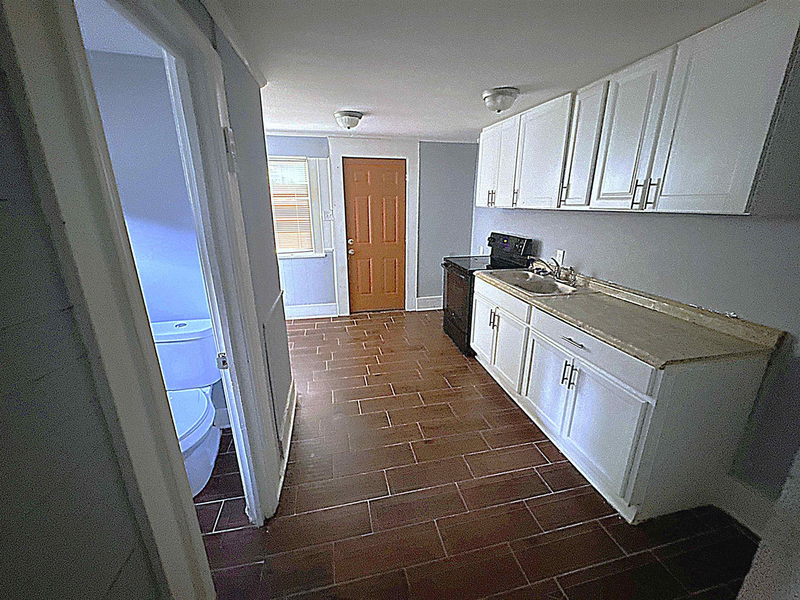 767 Semmes Street Memphis, TN 38111 - Photo 11 of 23 a kitchen with granite countertop stainless steel appliances a stove a sink and a refrigerator