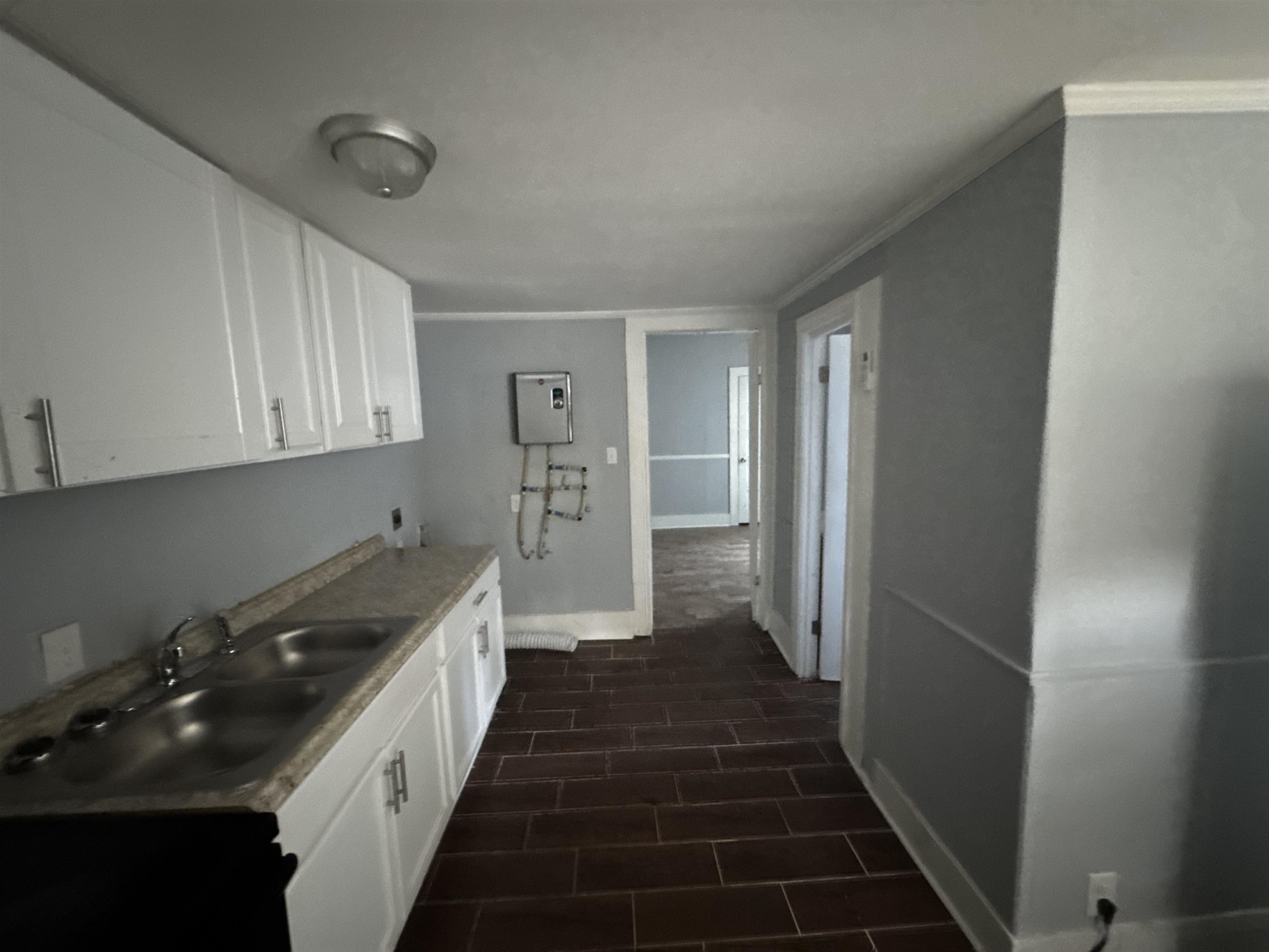 767 Semmes Street Memphis, TN 38111 - Photo 12 of 23 a kitchen with sink a refrigerator and cabinets