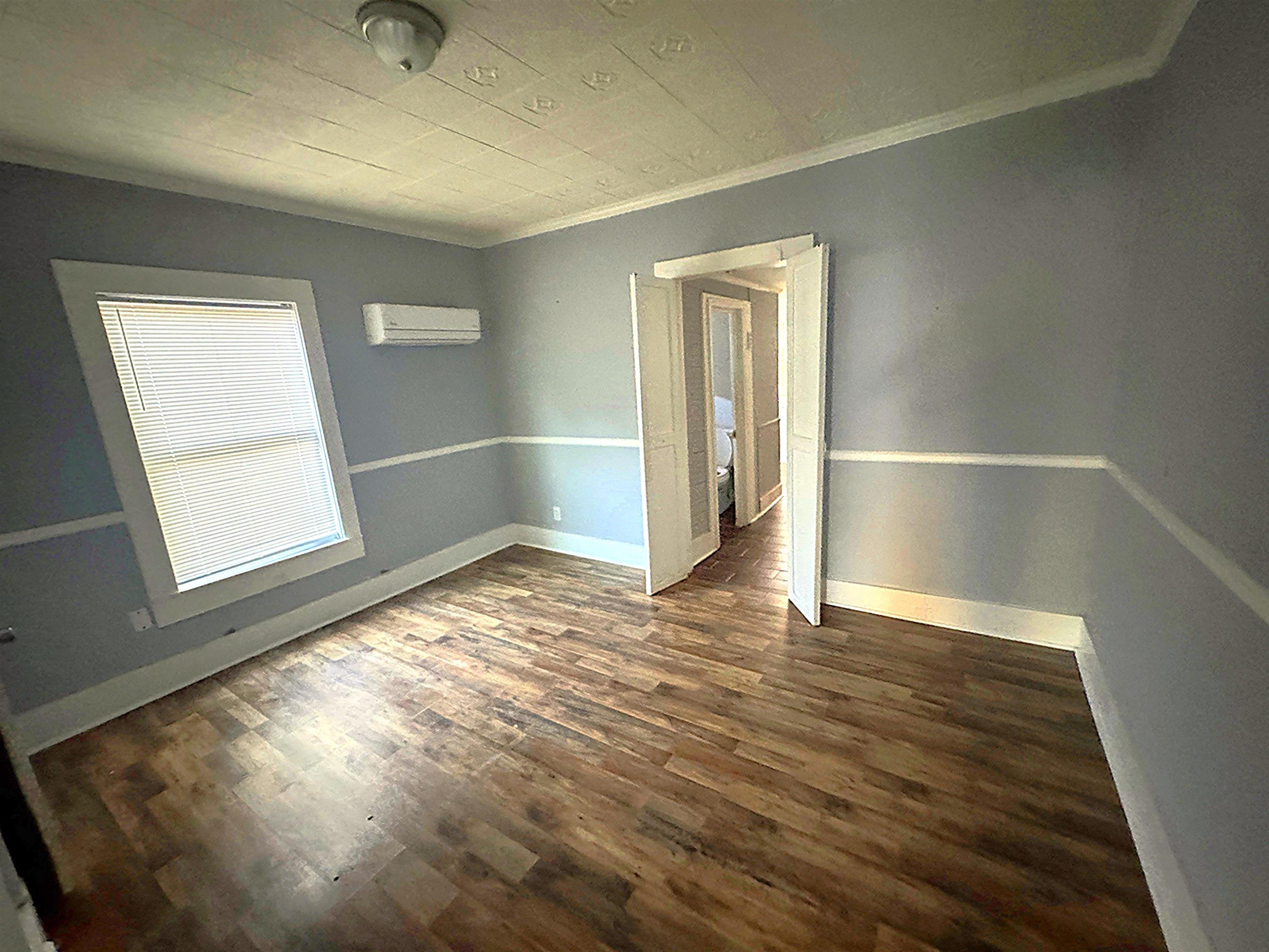767 Semmes Street Memphis, TN 38111 - Photo 13 of 23 an empty room with wooden floor and windows