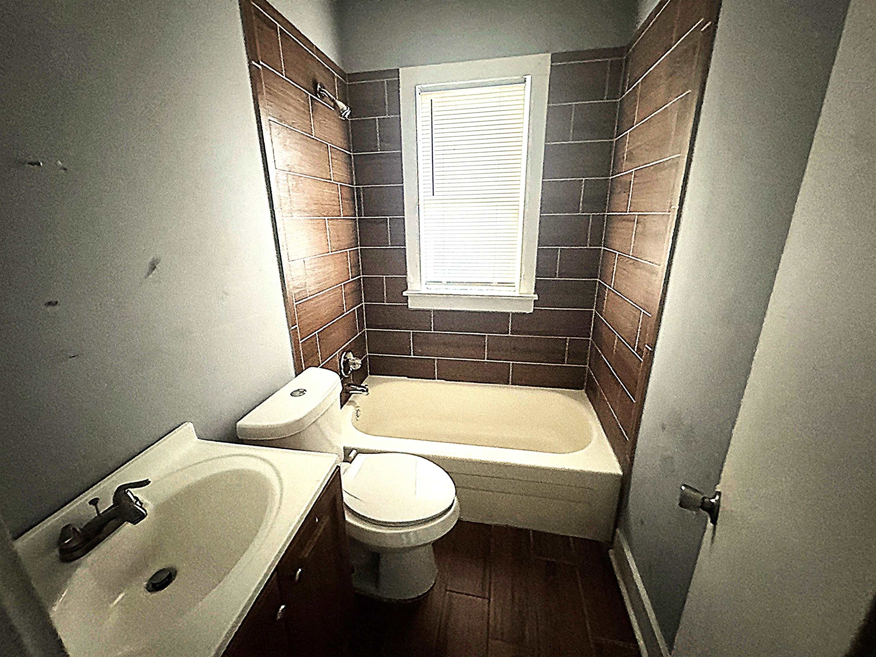 767 Semmes Street Memphis, TN 38111 - Photo 16 of 23 a bathroom with a toilet and a bathtub