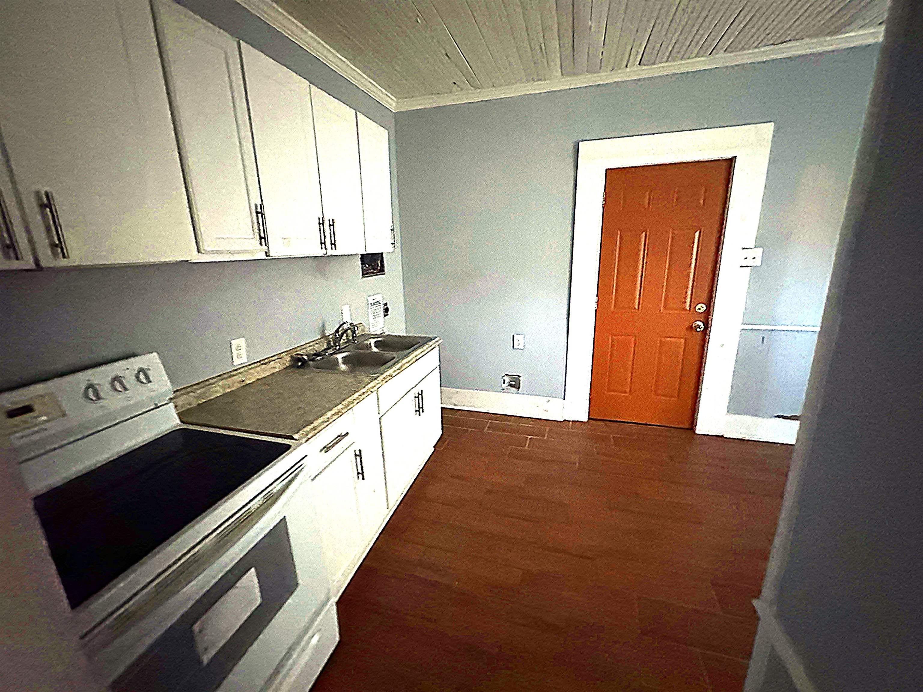 767 Semmes Street Memphis, TN 38111 - Photo 18 of 23 a kitchen with a stove and white cabinets