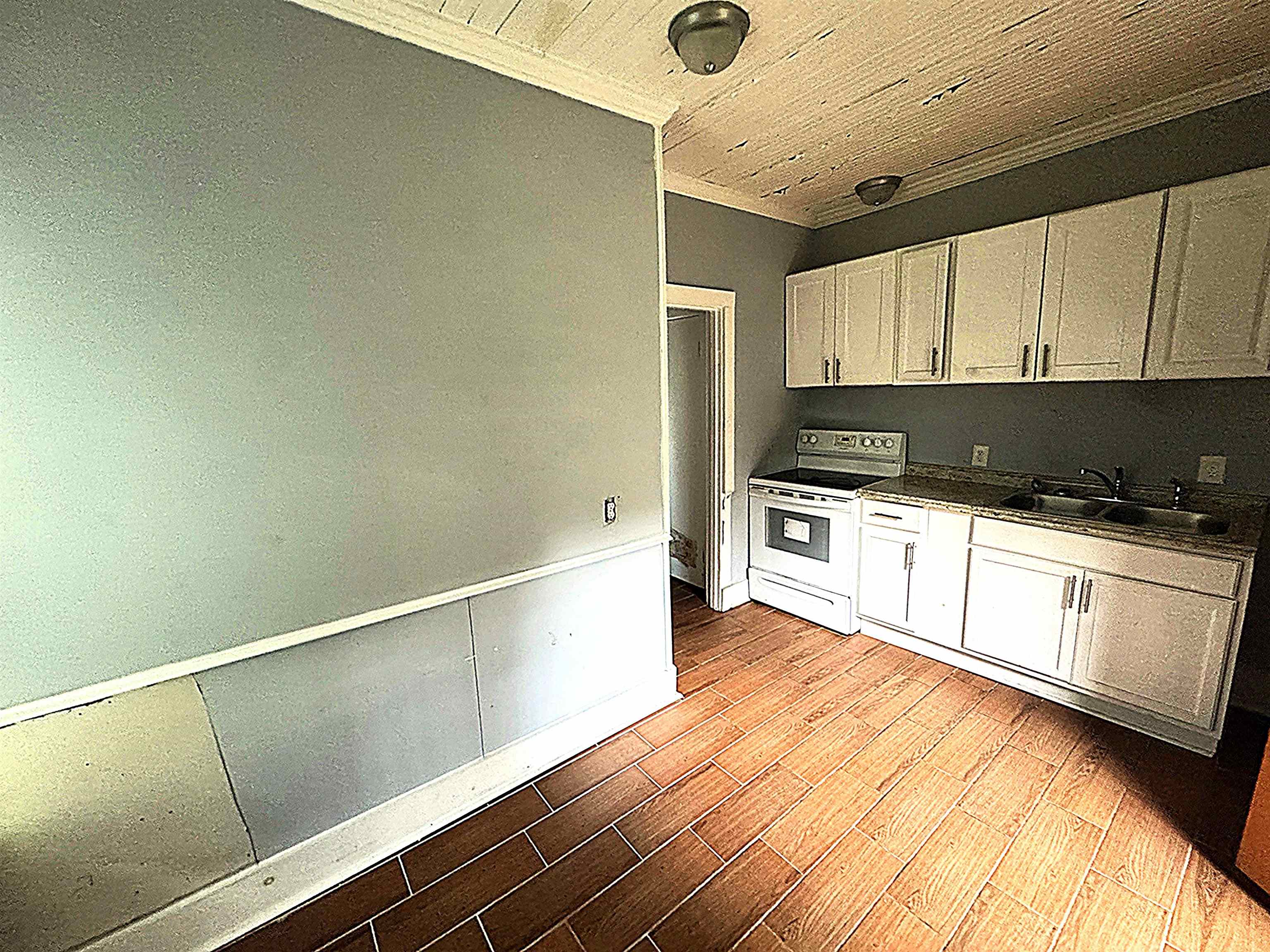 767 Semmes Street Memphis, TN 38111 - Photo 22 of 23 a kitchen with a sink a stove and cabinets