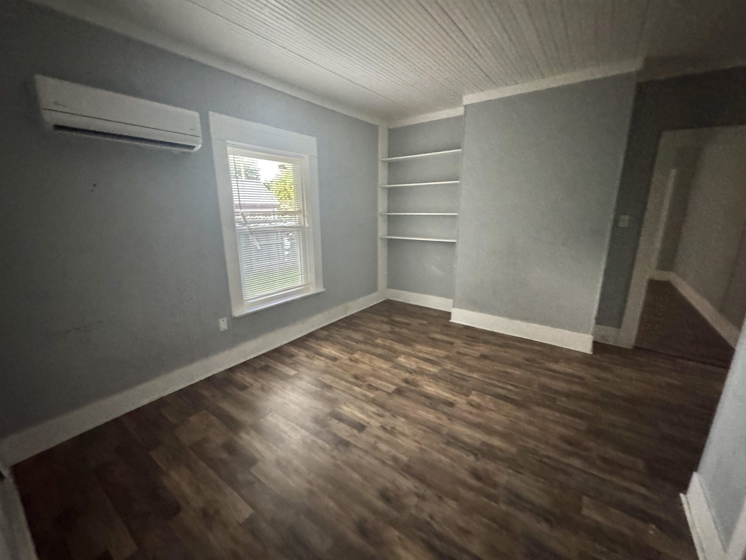 767 Semmes Street Memphis, TN 38111 - Photo 7 of 23 an empty room with wooden floor and windows