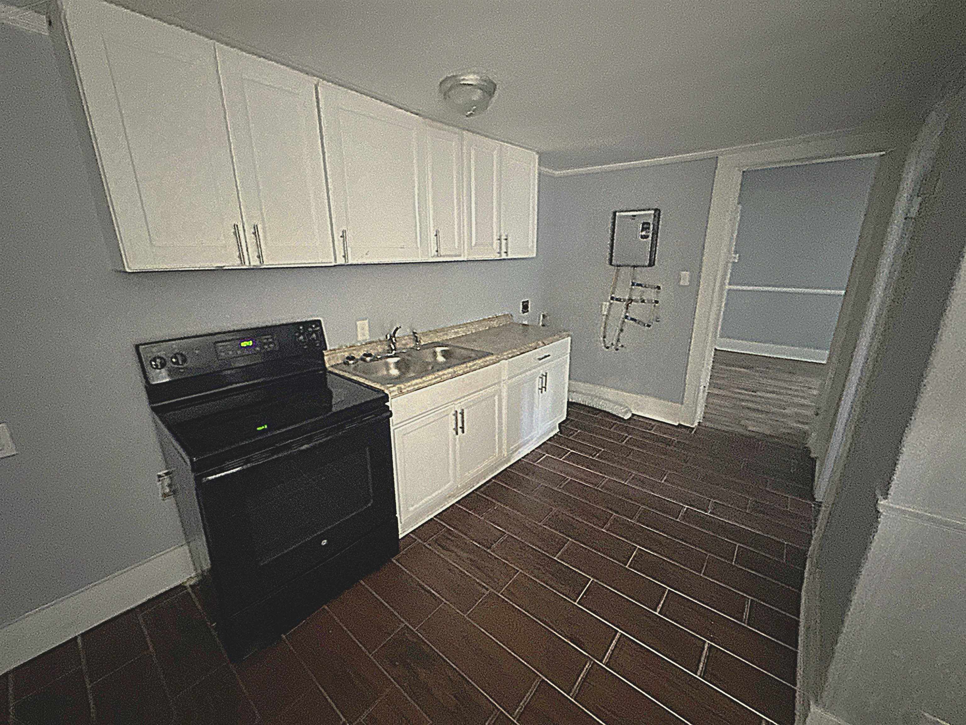 767 Semmes Street Memphis, TN 38111 - Photo 9 of 23 a kitchen with a sink and cabinets