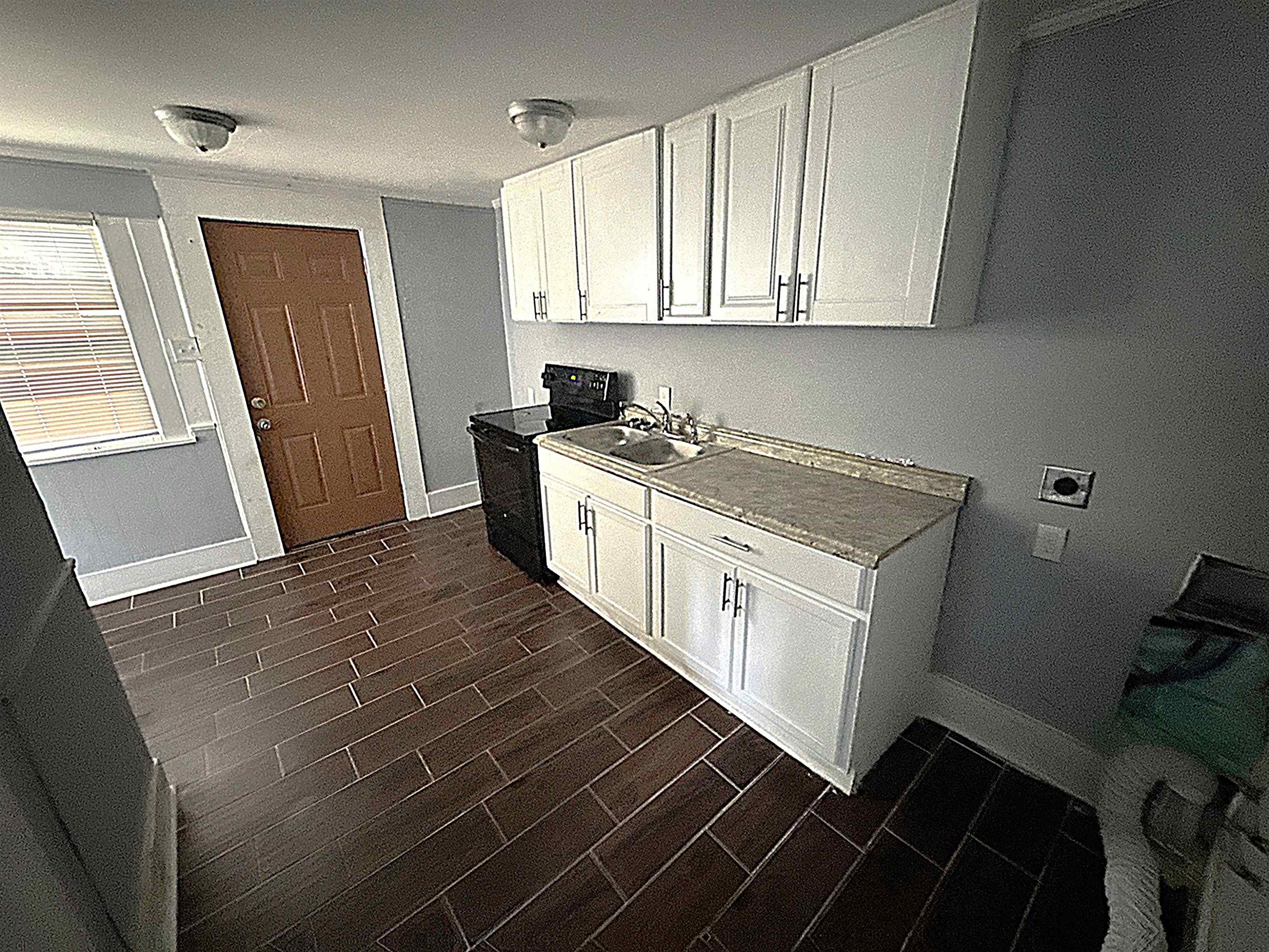 767 Semmes Street Memphis, TN 38111 - Photo 10 of 23 a kitchen with a sink stove and cabinets
