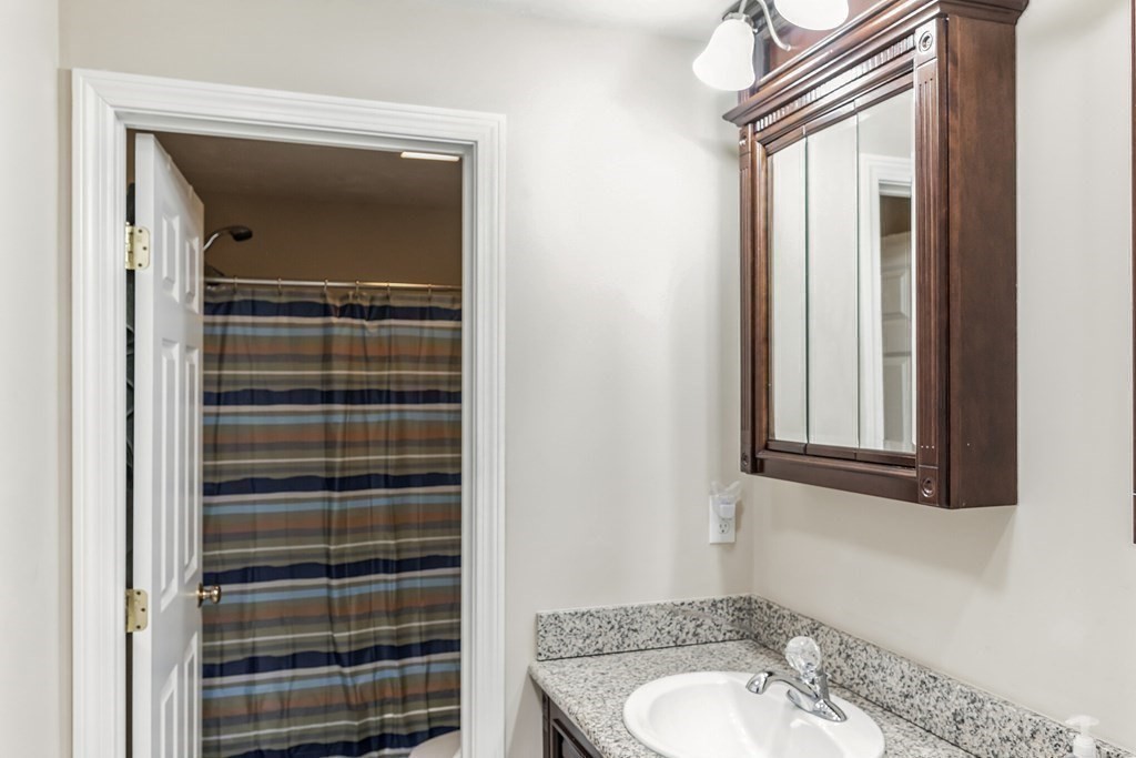 27 Honeysuckle Road Worcester, MA 01607 - Photo 16 of 30 a bathroom with a sink a vanity and a mirror