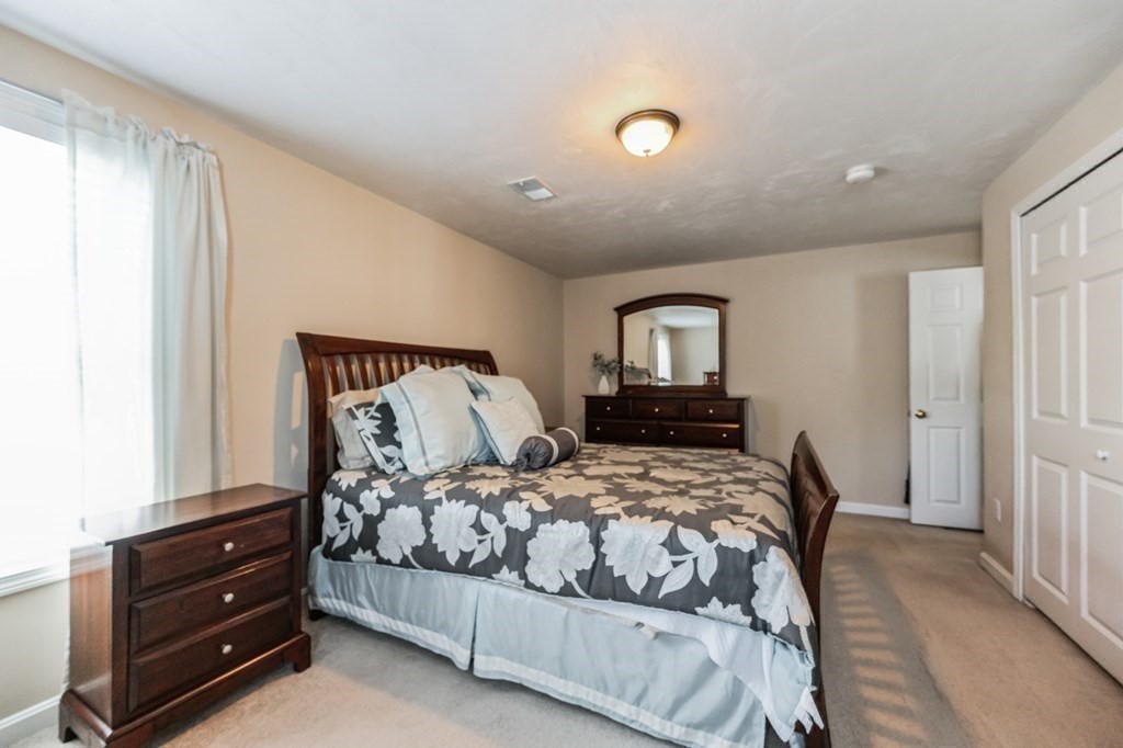 27 Honeysuckle Road Worcester, MA 01607 - Photo 17 of 30 a bedroom with a bed and a window